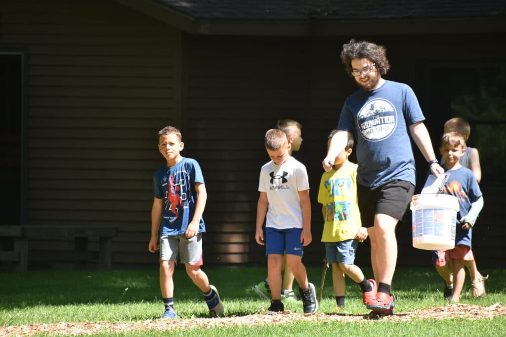 Arts and crafts leader helping campers with projects
